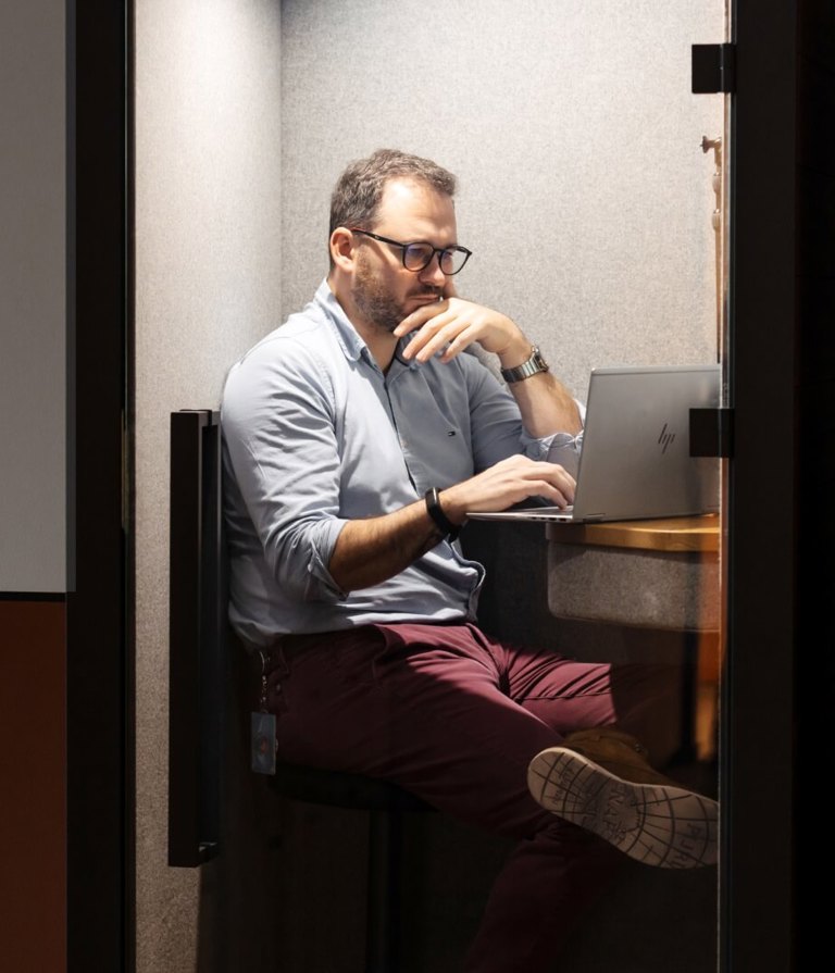 Man working on computer at the Warsaw office in Poland. 