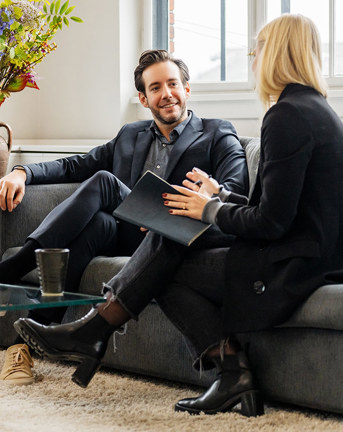 People talking while sitting in sofas