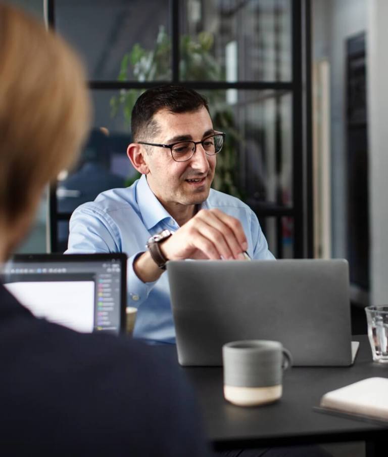 People sitting around a table in the Copenhagen office in Denmark during a meeting.